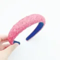 Detailed view of the pink crystal embellished padded headband, showcasing the sparkling textured surface. - Red