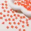 Mini jelly four-petal flower acrylic charms for DIY jewelry making, earrings and keychain decor. - Orange