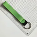 Close-up detail shot of green wristlet lanyard strap with metal key ring, premium material. - Fruit Green