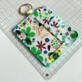 Floral print card holder detail view, PU leather ID badge case with keychain and transparent window. - Mint Green
