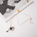Lange rosegouden ketting met blauw kristal boze oog hanger en fonkelende strass steentjes - Goud/Koningsblauw