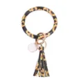 Portachiavi tondo in pelle PU girasole con ciondolo nappa dettaglio elegante. - Girasole