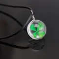 Four leaf clover glass ball pendant necklace, real plant specimen in clear glass sphere. - Four-Leaf Clover / Black Chain