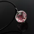 Exquisite transparent glass sphere pendant featuring delicate pink dried flower specimens inside. - Magenta Gypsophila / Brown Chain