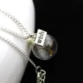Silver chain necklace featuring a glass globe pendant with real dandelion seeds and a wish charm. - Silver Short