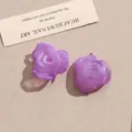 Close-up of ice-clear purple acrylic rose flower DIY jewelry patches for earrings and crafts. - Purple