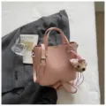 Pink leather tote bag for women, stylish bucket shoulder bag with cute bear charm and strap. - Pink With Charm