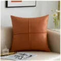 Detailed view of the brown PU faux leather sofa cushion featuring elegant cross-stitching design. - Bronze 45x45cm