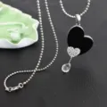 Silver tone beaded chain necklace with black heart pendant, rhinestone detail, and crystal drop. - Double Heart Style
