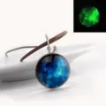 Close-up detail of the glowing galaxy glass cabochon pendant necklace with brown cord. - Stardust 4