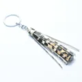 Closeup of a stylish leopard print leather tassel keychain with durable metal hardware. - Sunflower