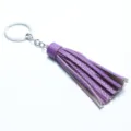 Purple leather tassel keychain with silver metal ring, detailed view of bag charm accessory. - Purple