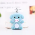 Cute blue plush pig keychain detail shot showing soft velvet texture and metal ring. - Lake Blue