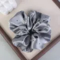 Gray polka dot satin hair scrunchie detail view, elegant hair tie for women's daily styling. - Gray Satin