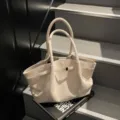 Minimalist beige suede tote bag with double handles and elegant strap detail for women. - T Off-White