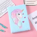 Close-up detail of cute fluffy unicorn notebook with soft blue plush cover and embroidery. - 14.5*21cm / Blue