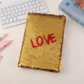 Detailed shot of a sparkly gold and red reversible sequin notebook with LOVE text. - Red Love