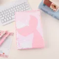 Close-up detail of the pink reversible sequin notebook with mermaid tail pattern on desk. - Pink Mermaid Tail Style