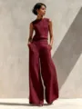 Detail shot of the maroon sleeveless top and wide leg pants set with contrast black stitching. - Burgundy