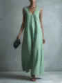 Detailed view of the light green sleeveless maxi dress, showcasing elegant drape and V-neck. - Light Green