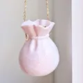 Exquisite pink marble texture evening bag detail, featuring cute ruffle bag mouth and gold chain. - Pink