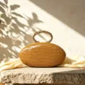French luxury oval clutch bag with PU crocodile texture and metal handle for women. - Tan