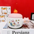 Ceramic mug detail showcasing cute rabbit and bear cartoon graphics with orange lid design. - Pink Flat Rabbit