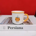 Cute cartoon tiger ceramic mug with yellow handle and rim, ideal detail shot for home decor. - Orange Birthday Hat