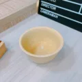 Close-up detail of a pastel yellow ceramic bowl, perfect for solo dining and cute table decor. - 4.75 Inch Rice Bowl