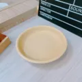 Detailed shot of a cute cream yellow ceramic small plate, minimalist tableware style for daily use. - 8 Inch Round Plate
