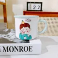 Close-up detail of the cute ceramic cartoon boy mug displayed on a stylish desk setup. - 320ml / Green Boy
