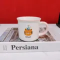 Ceramic mug detail shot featuring a cute cartoon tiger in a party hat and "HELLO" text. - Pink Birthday Hat