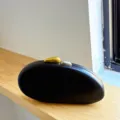 Minimalist matte black acrylic egg-shaped evening clutch bag with unique gold silver stone clasps. - Black