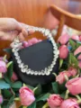 Black satin evening clutch featuring a stunning crystal rhinestone ring handle and elegant design. - Silk Black