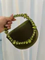 Green satin evening handbag featuring a stunning rhinestone encrusted circular handle for women. - Silk Dark Green