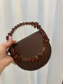 Brown evening handbag with amber-like jewel embellishments, stylish and elegant. - Silk Coffee