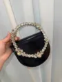 Black evening handbag featuring crystal circle handle, stylish party purse variant. - Leather Black
