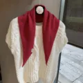 Detailed close-up of knitted triangle scarf paired with sweater, soft autumn women accessory. - One Size / China Red