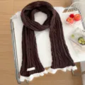 Brown knitted scarf with white lace trim, cozy winter fashion accessory close-up detail shot. - Coffee