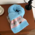 Close-up detail of cozy blue and pink knit winter scarf featuring classic Nordic patterned design. - 160x22cm / Light Blue