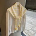 Detailed view of Japanese style striped knit scarf with cute pom-poms, soft and warm accessory. - 135x80cm / Yellow and White Stripes