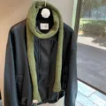 Detail view of the solid olive green narrow wool long scarf, stylish knit baguette neck wrap. - Army Green