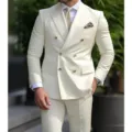 Close-up detail of a stylish cream double-breasted men's suit jacket with lapel and buttons. - M / Top And Bottom / White