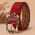 Red vintage leather belt for women with embossed floral pattern and antique brass pin buckle. - Red