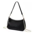 Close-up detail of the black leather baguette bag featuring elegant gold chain and zipper closure. - Black