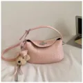 Pink woven underarm shoulder bag with metal turn lock and cute teddy bear keychain charm. - With Pendant / Pink