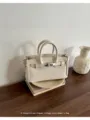 Elegant white lychee pattern leather handbag with metal lock and double handles for women. - White