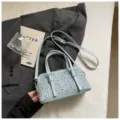 Light blue studded denim bowling bag with top handles and adjustable shoulder strap. - Blue No Charm