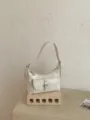 Minimalist vintage French shoulder bag, chic white PU leather dumpling handbag with front pocket. - White