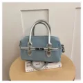 Stylish denim boston bag with metallic silver handles and chic front lock closure design for women. - Light Blue With Silver